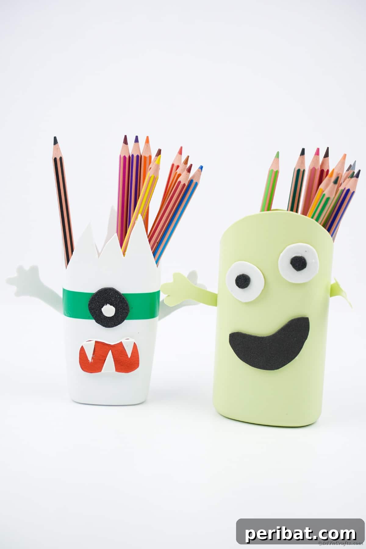 Monster pencil holders on white surface
