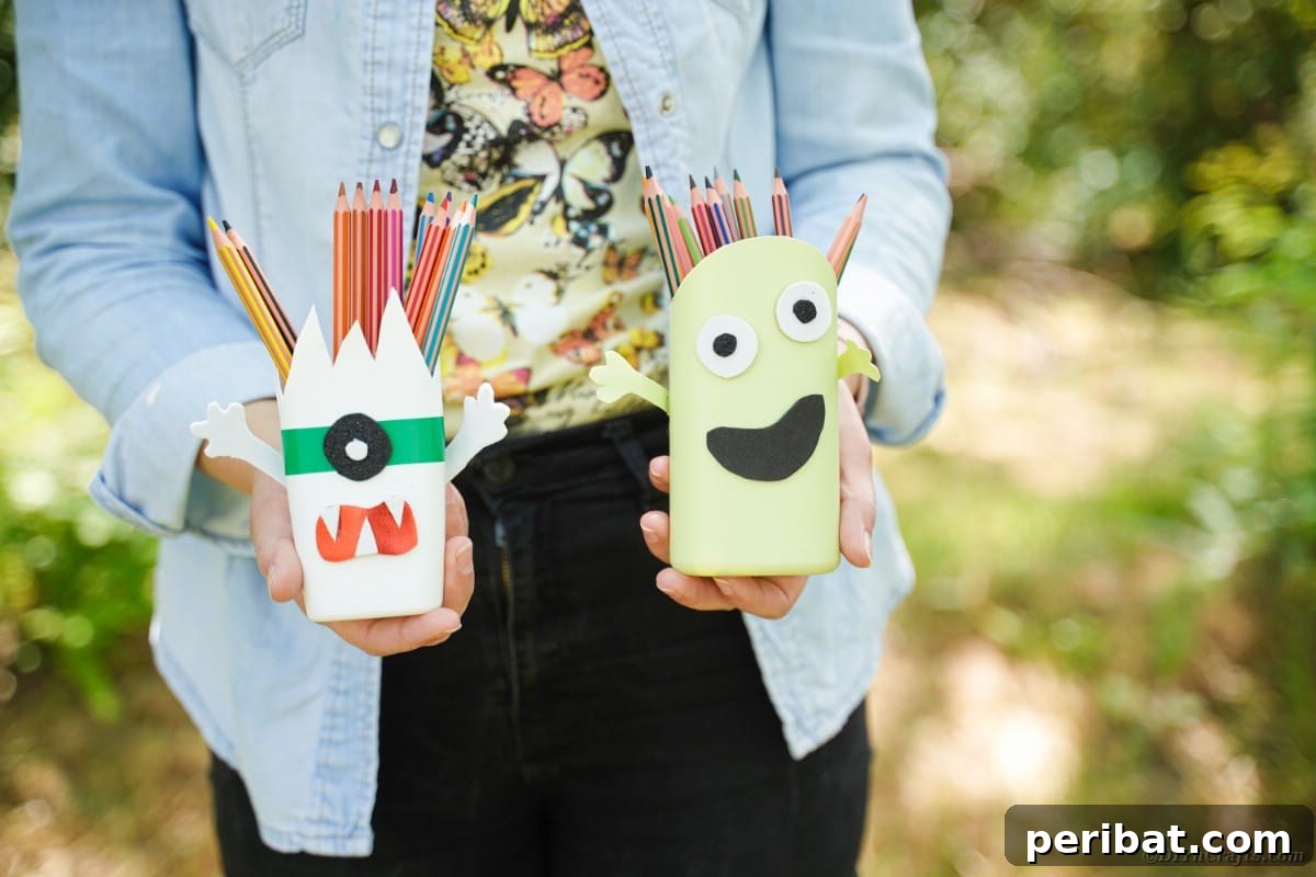 Woman holding monster pencil cans