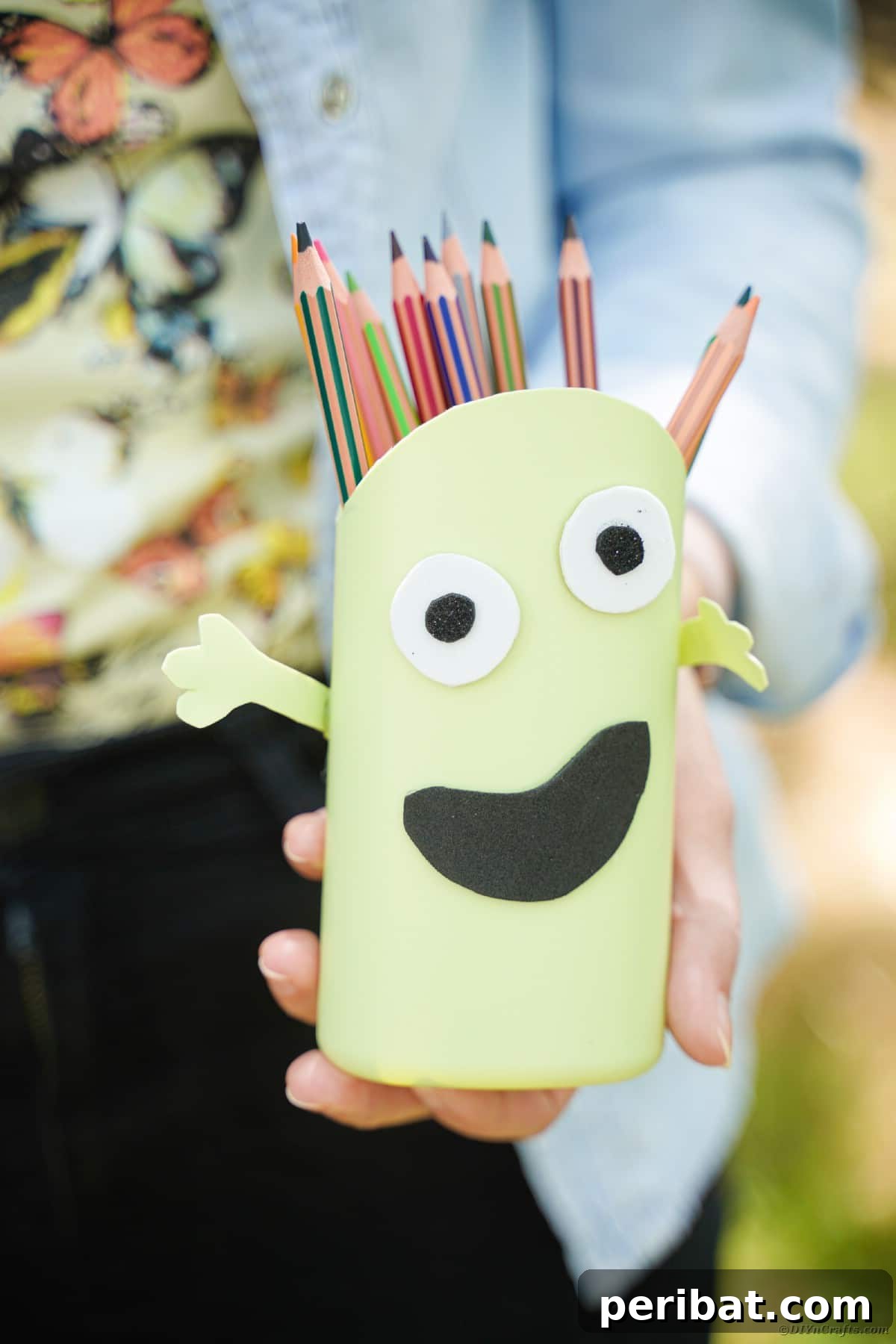 Woman holding monster pencil cans