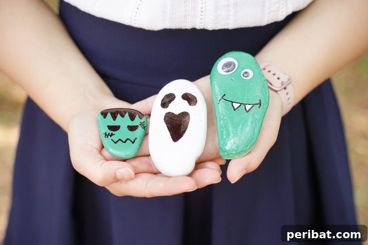 Spooky Sweet Halloween Rock Art 3 Woman holding painted Halloween rocks