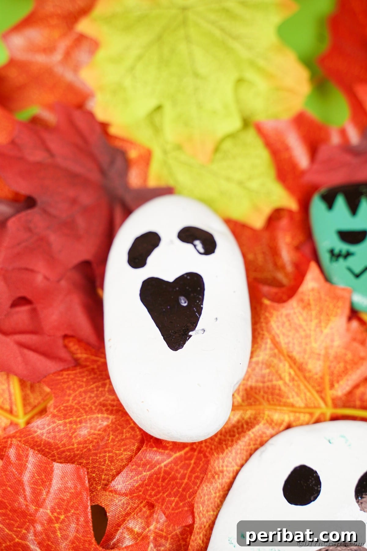 Spooky Sweet Halloween Rock Art 16 Ghost painted rock on leaves