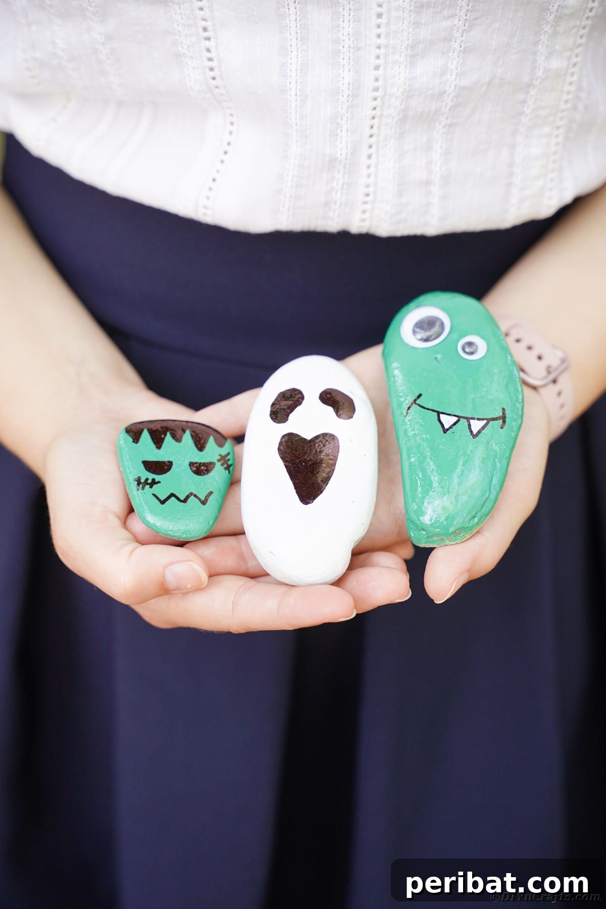 Spooky Sweet Halloween Rock Art 18 Woman holding painted Halloween rocks