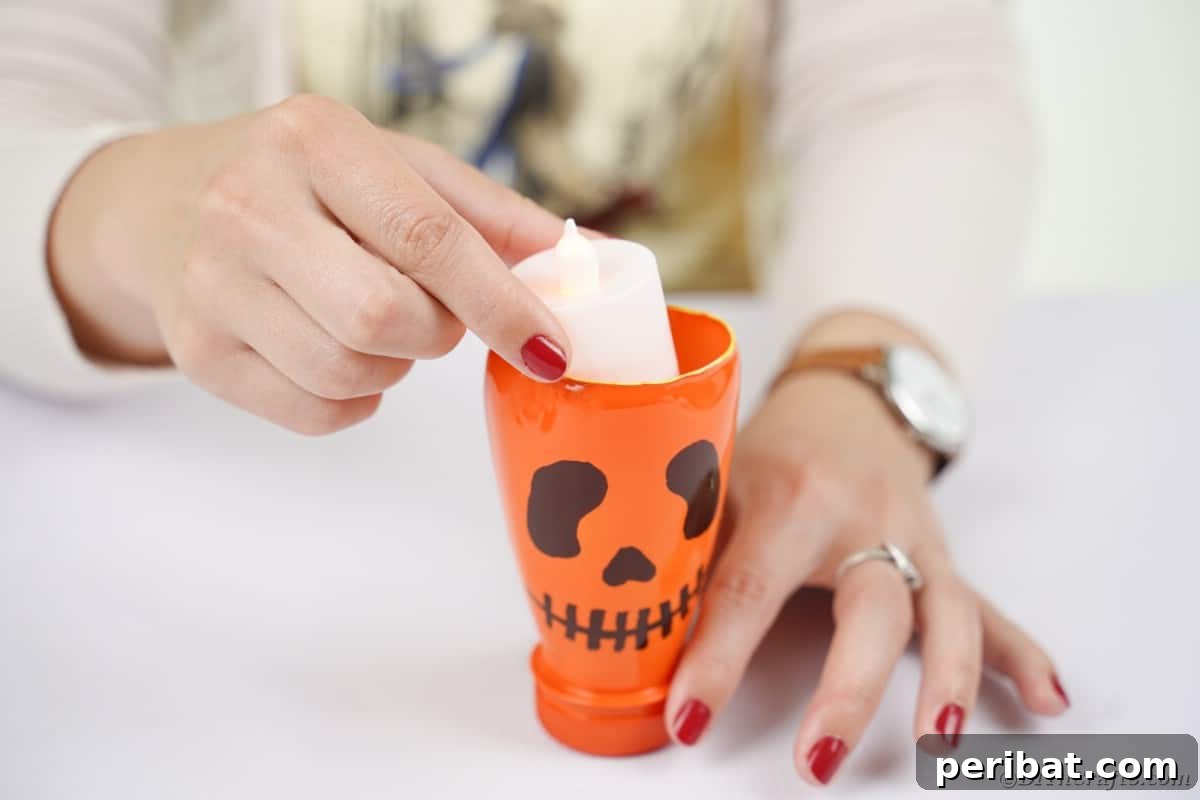 Charming Recycled Bottle Jack O Lantern 12 Inserting a flameless candle inside a finished pumpkin lantern