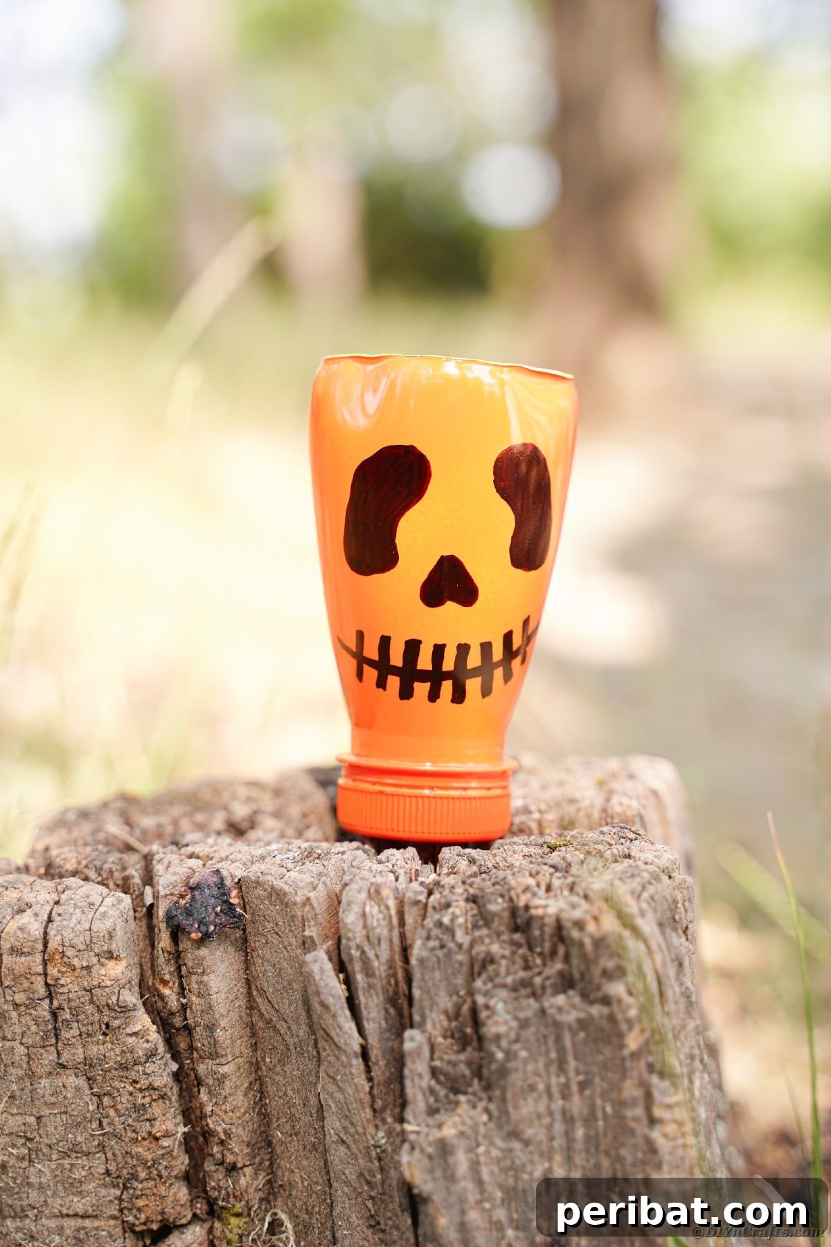 Charming Recycled Bottle Jack O Lantern 16 Pumpkin lantern displayed outdoors on a tree stump amidst foliage