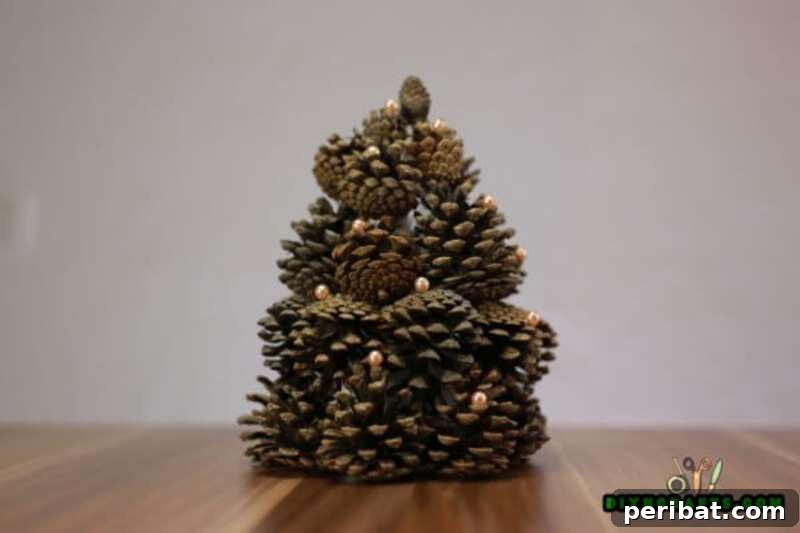 40+ Adorable Mini Christmas Tree Decor Ideas 12 A simple yet elegant miniature Christmas tree crafted from a pinecone, ideal for rustic holiday decor.
