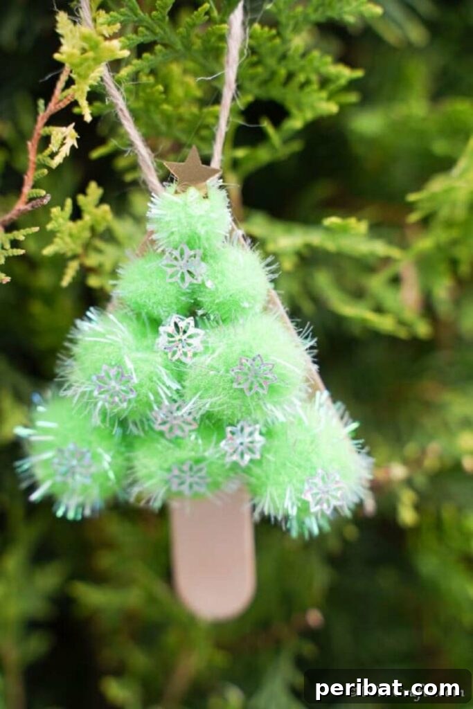 40+ Adorable Mini Christmas Tree Decor Ideas 17 Adorable miniature pom pom Christmas tree ornament crafted on a stick, perfect for kids' holiday crafting.