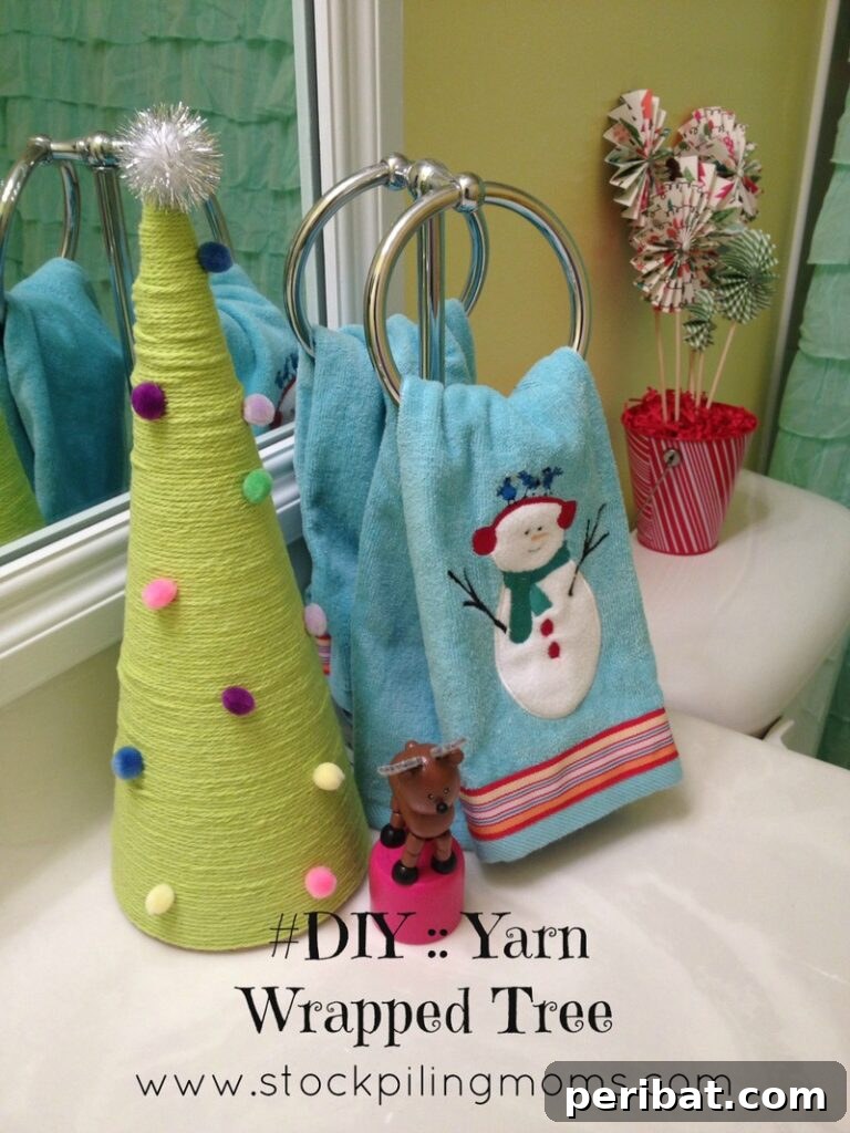 40+ Adorable Mini Christmas Tree Decor Ideas 21 Cozy yarn-wrapped Christmas tree displayed on a counter, offering a soft and customizable decoration.
