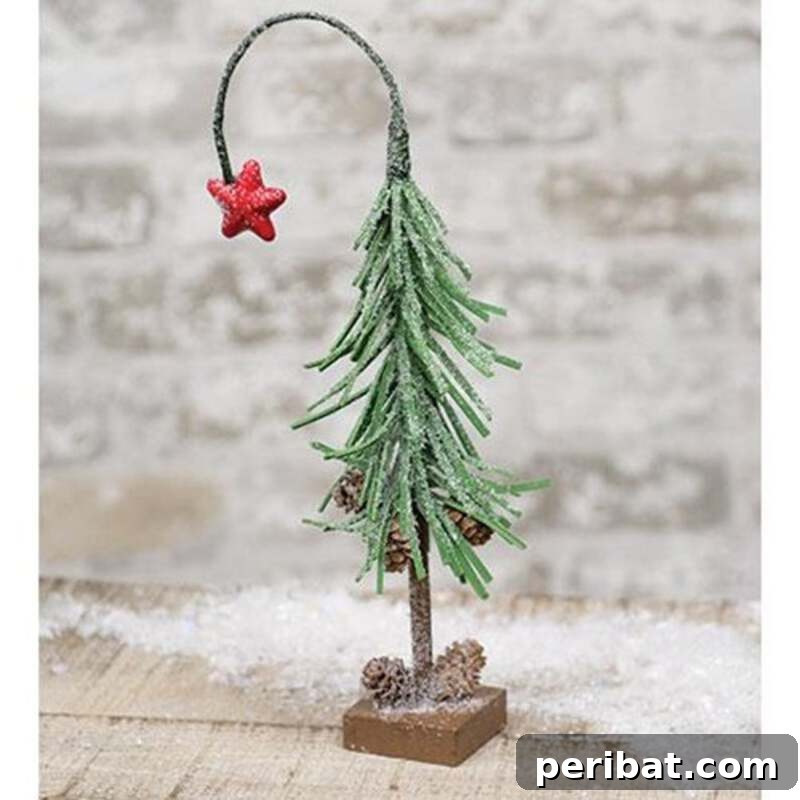 40+ Adorable Mini Christmas Tree Decor Ideas 26 Magical snowy shooting star miniature Christmas tree, a charming and elegant addition to any holiday display.