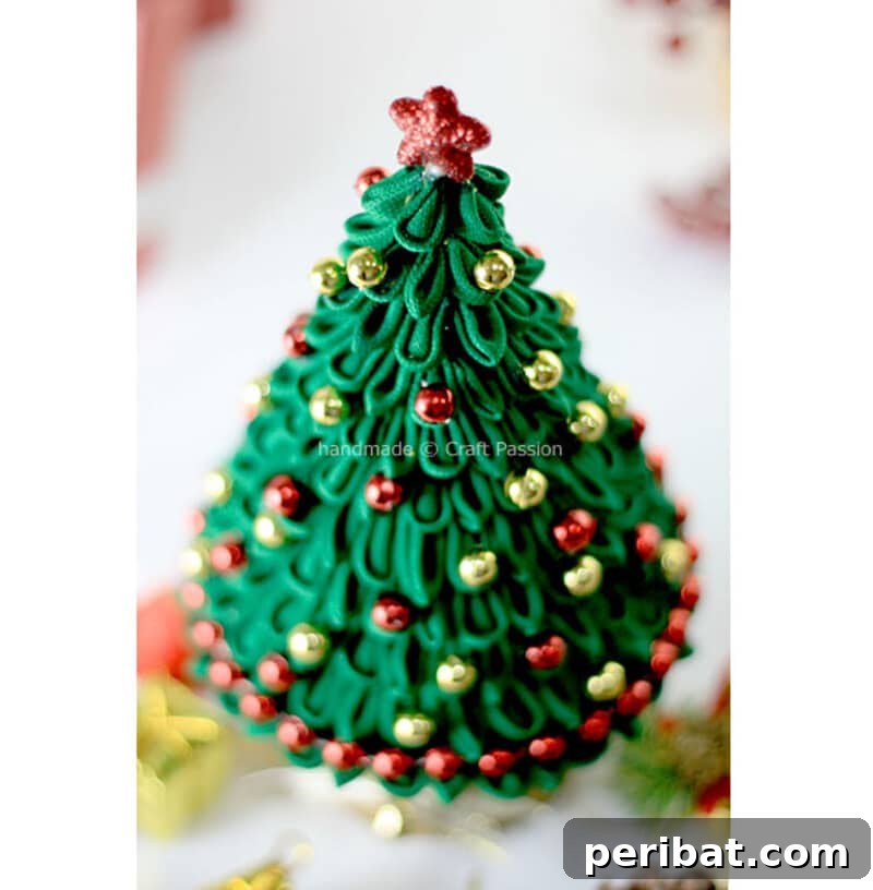 40+ Adorable Mini Christmas Tree Decor Ideas 28 Intricate green ribbon Kanzashi Christmas tree, an elegant and artistic centerpiece for holiday tables.