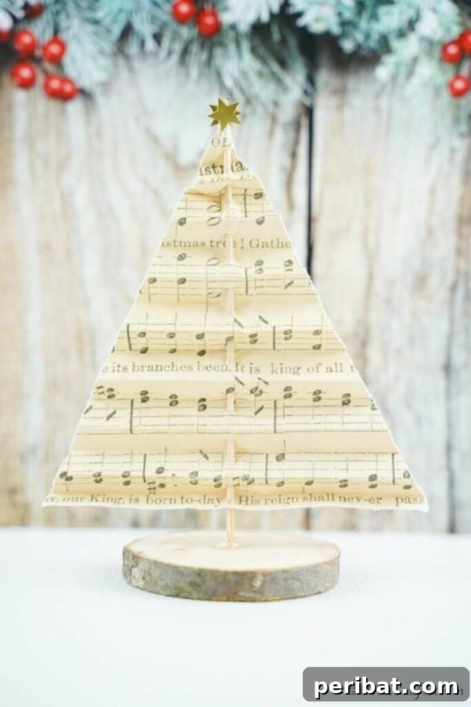 40+ Adorable Mini Christmas Tree Decor Ideas 4 Elegant music sheet folded into a mini Christmas tree, showcasing a unique paper craft for holiday decor.