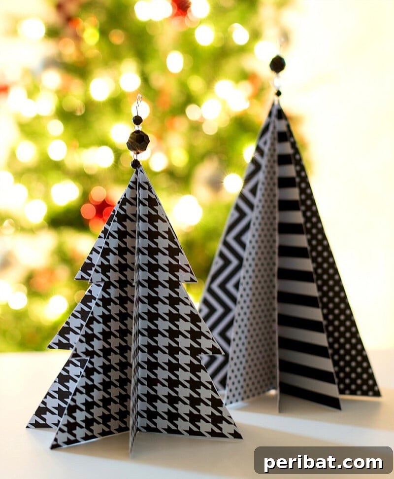 40+ Adorable Mini Christmas Tree Decor Ideas 34 Stylish black and white craft paper Christmas tree, a budget-friendly and quick DIY decoration idea.