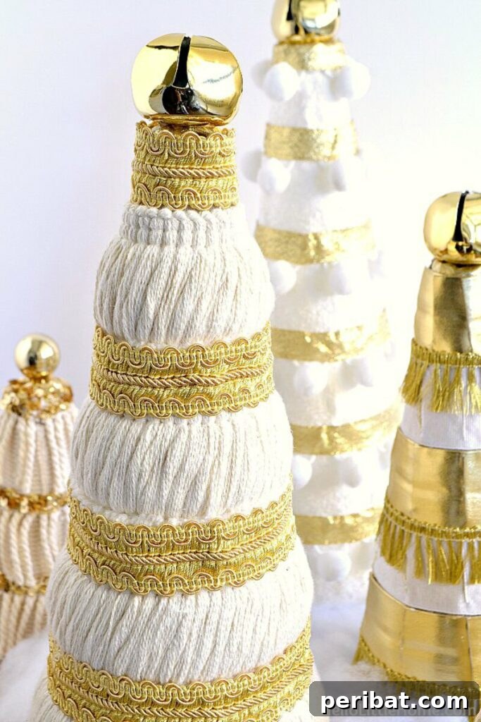 40+ Adorable Mini Christmas Tree Decor Ideas 36 Sophisticated ribbon and tassel elegant Christmas trees, perfect for a chic holiday dinner table setting.