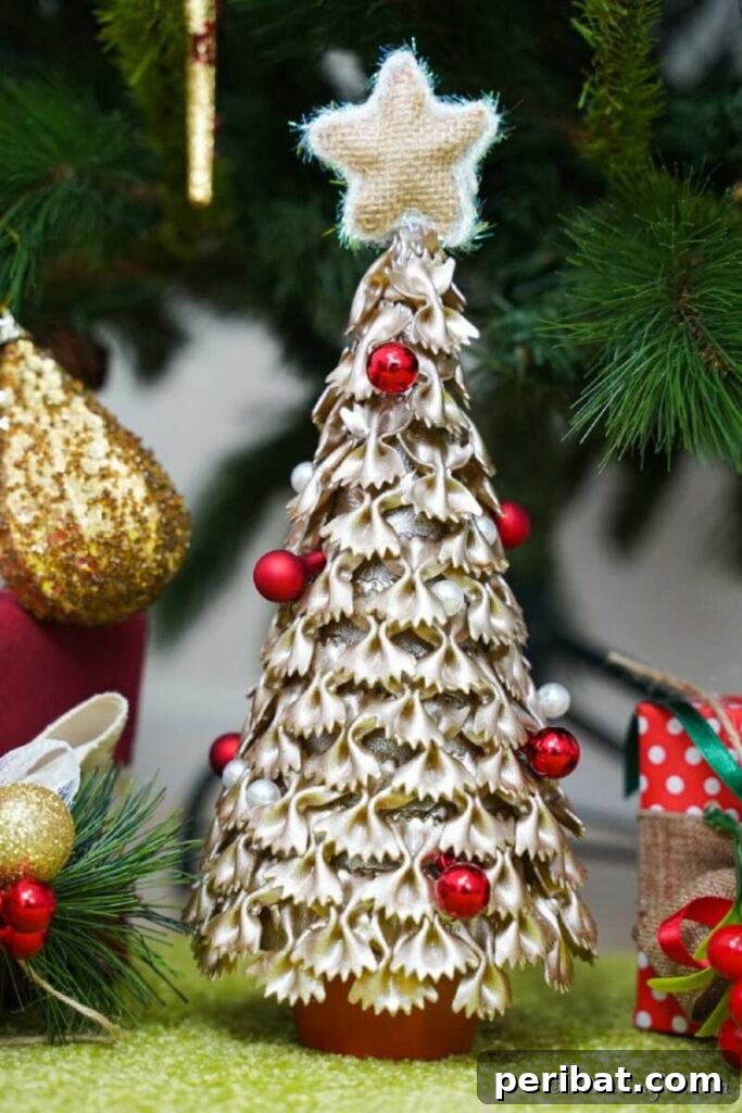 40+ Adorable Mini Christmas Tree Decor Ideas 7 Elegant gold pasta Christmas tree, a creative and shimmering DIY holiday decoration.
