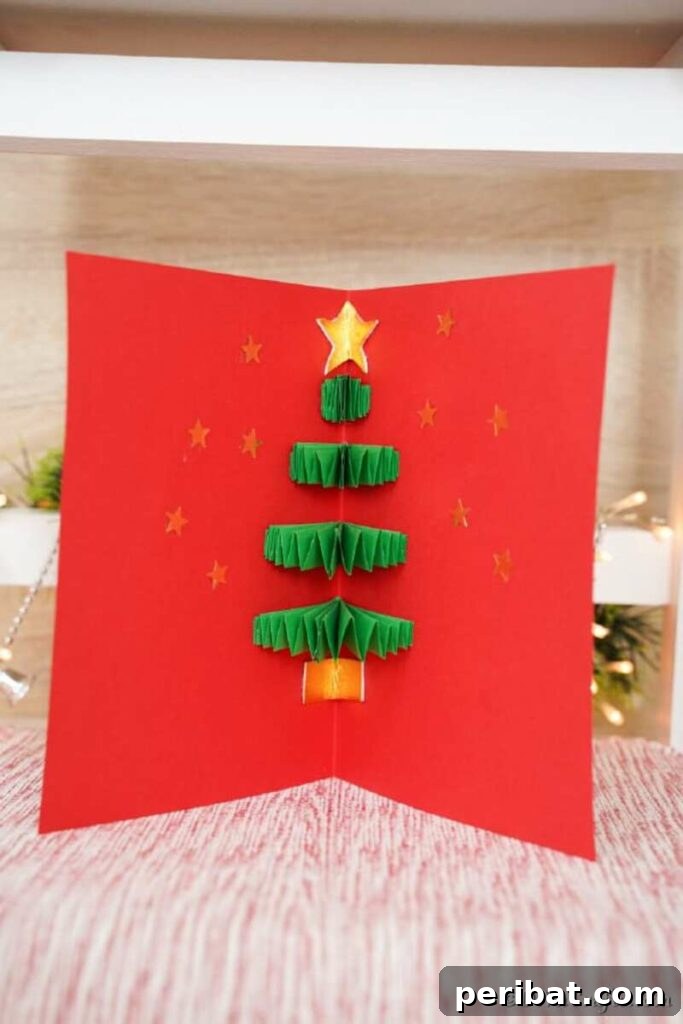 40+ Adorable Mini Christmas Tree Decor Ideas 10 Festive red Christmas card featuring a beautiful 3D paper Christmas tree design inside.