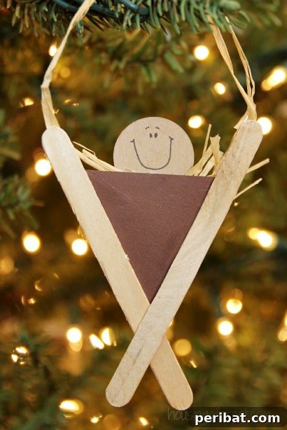 Delightful Christmas Popsicle Stick Creations for Kids 27 Popsicle Stick Manger Craft Ornament Displayed on a Christmas Tree