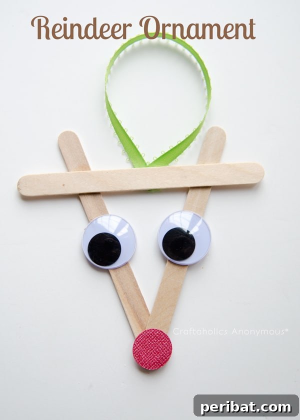 Delightful Christmas Popsicle Stick Creations for Kids 33 Rudolph the Red-Nosed Reindeer Craft Stick Ornament on a White Table