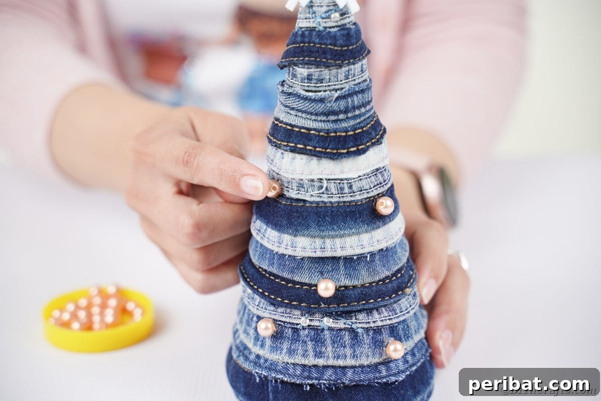 Upcycled Denim Mini Christmas Tree 16 Gluing beads on denim tree