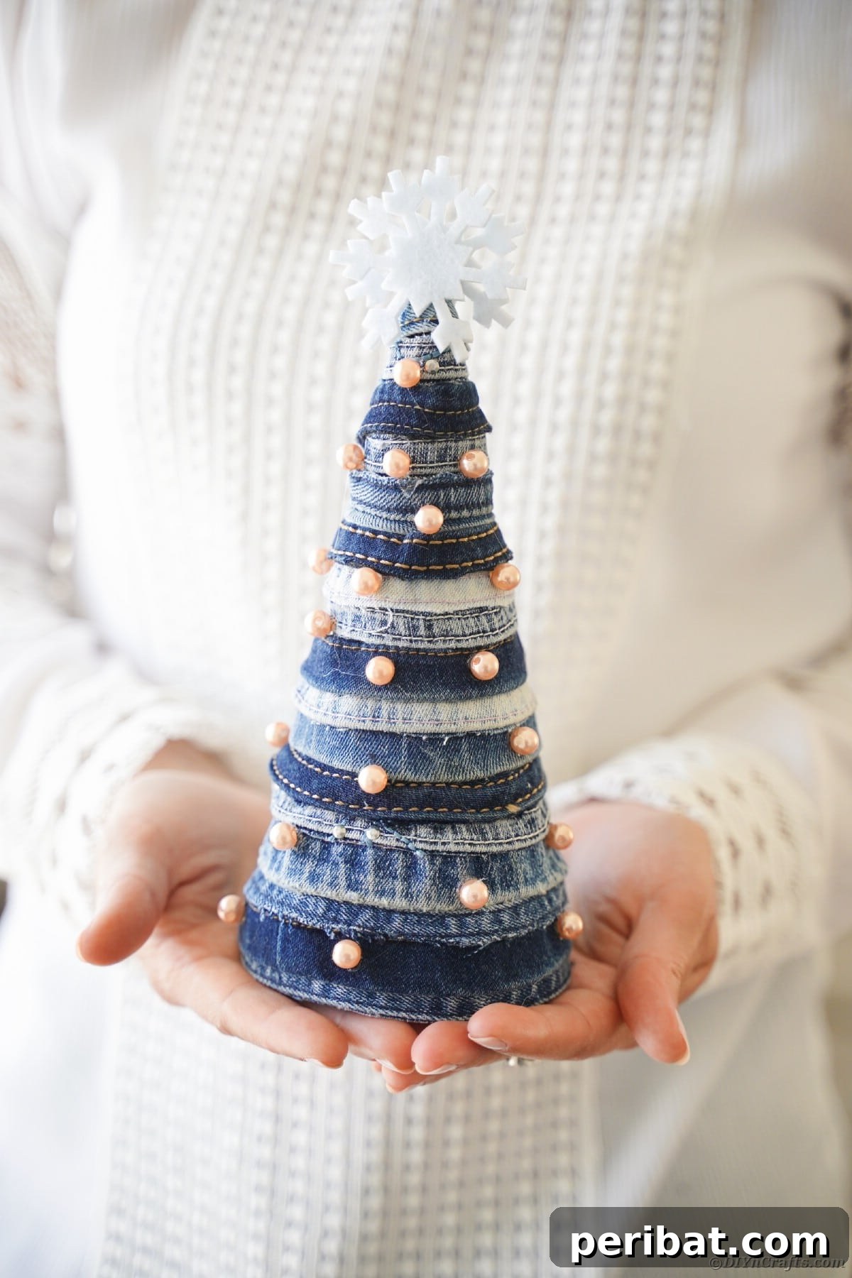 Upcycled Denim Mini Christmas Tree 17 Woman holding mini denim tree