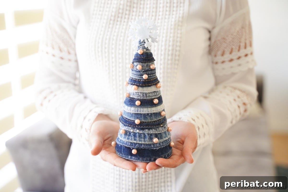 Upcycled Denim Mini Christmas Tree 3 Woman holding mini denim tree