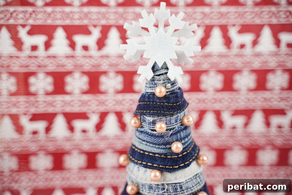 Upcycled Denim Mini Christmas Tree 5 Mini Christmas tree in front of red holiday paper