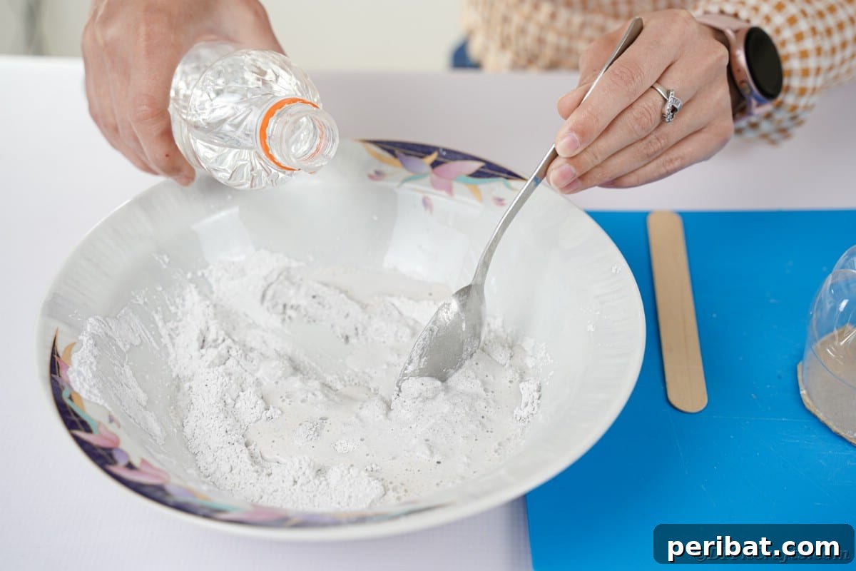Mixing plaster of Paris in a bowl, preparing it for application.