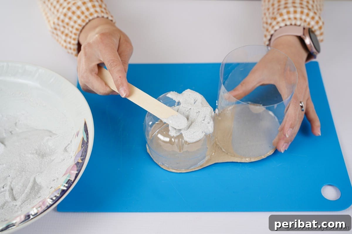 Spreading plaster over the plastic bottle pieces to create texture.