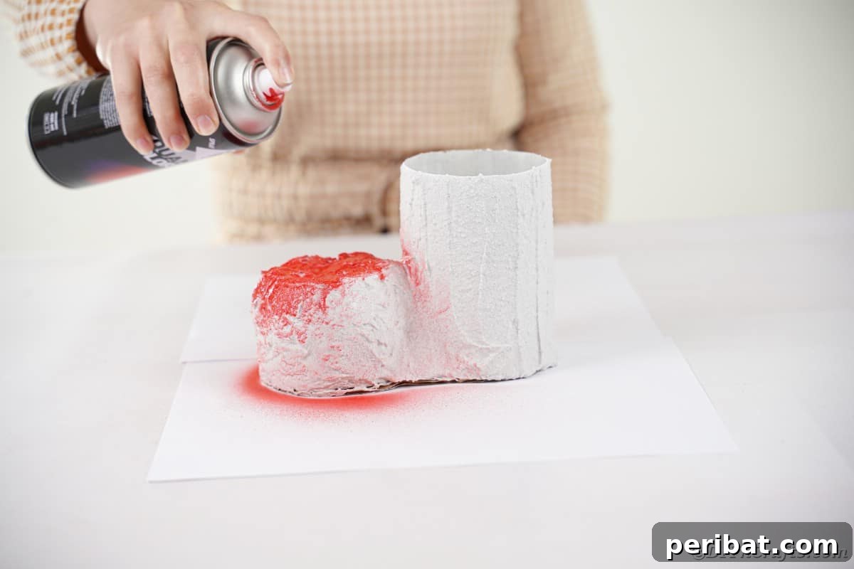 A Santa boot being painted red with spray paint.
