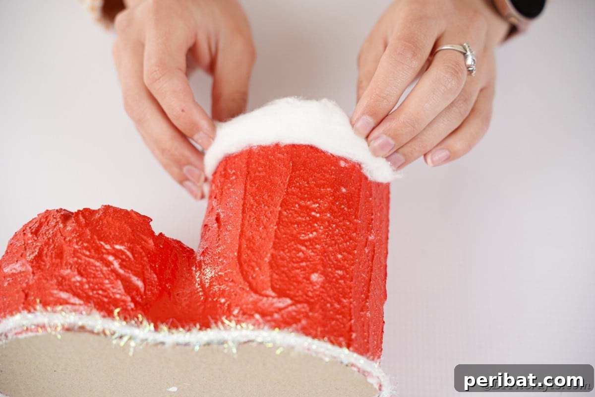 Attaching cotton batting to the top of the boot to create a cuff.