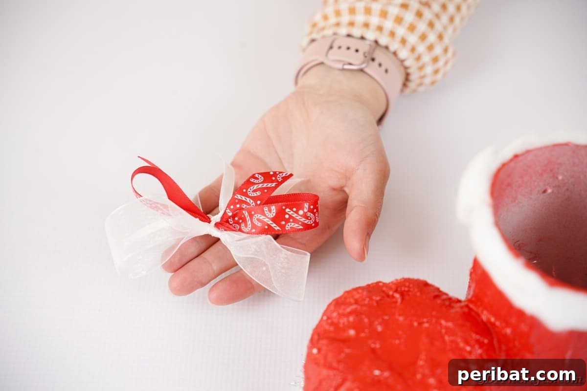 Tying ribbons to create a decorative holiday bow.