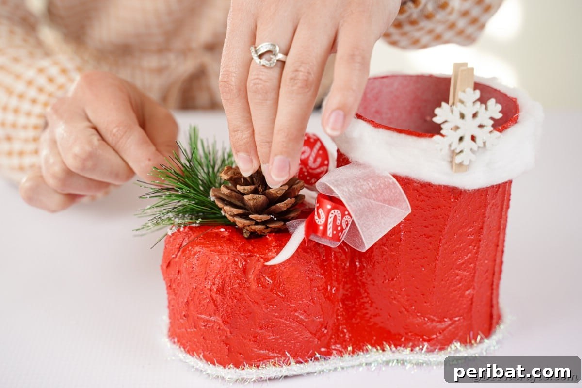 Adding a small holiday pick as a final embellishment to the Santa boot.