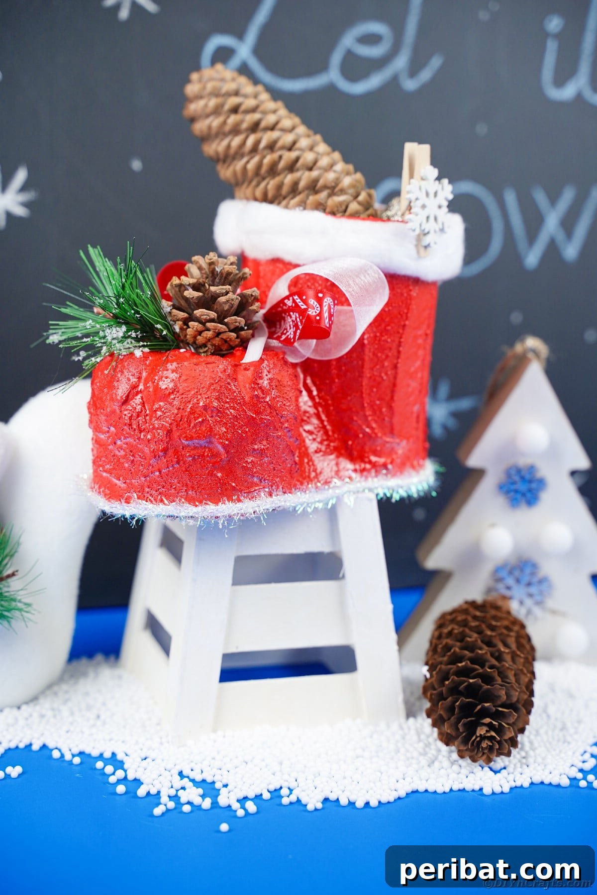 A beautifully finished Santa boot decoration, displayed by a chalkboard.