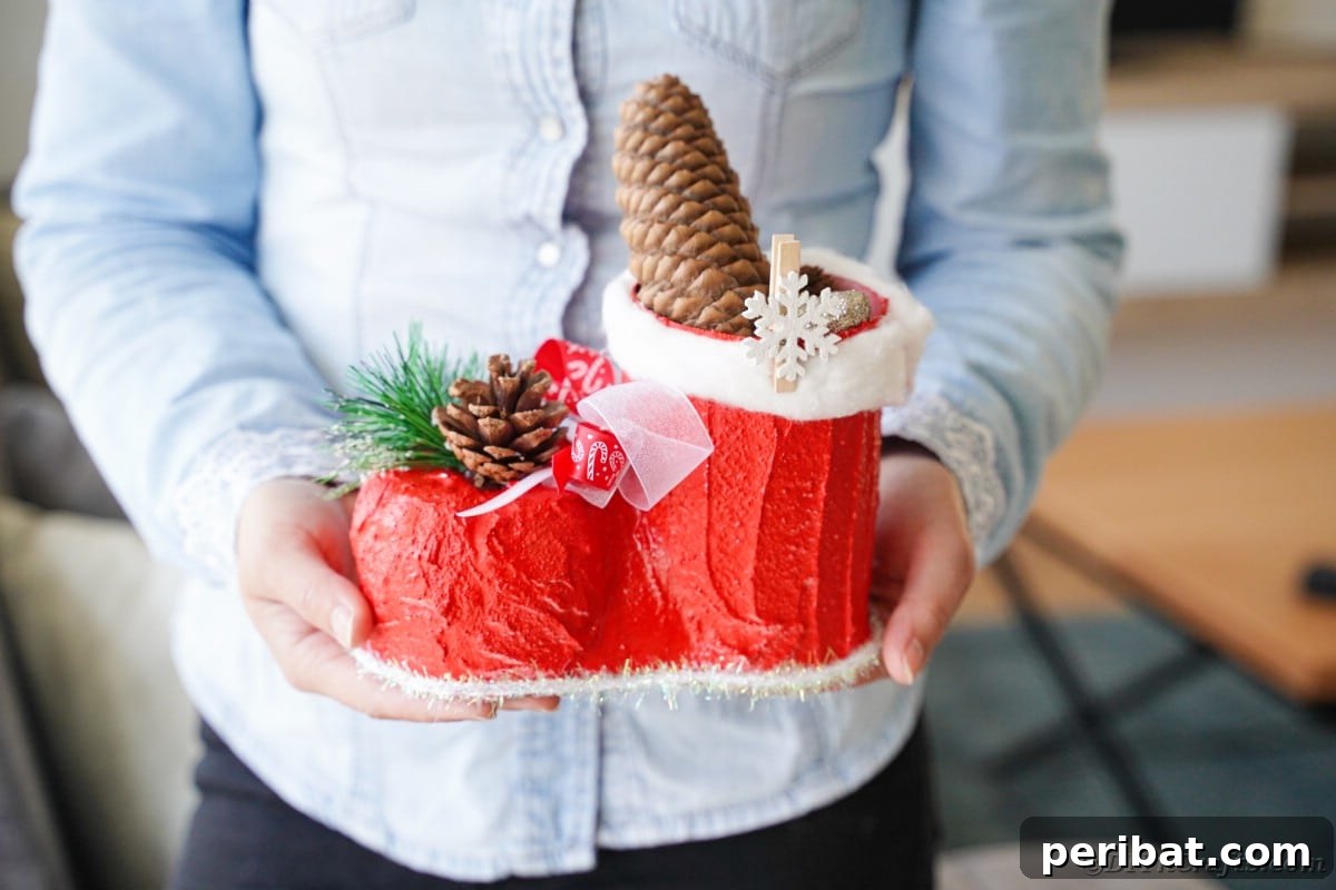 A woman proudly holding her completed, decorative Santa boot creation.