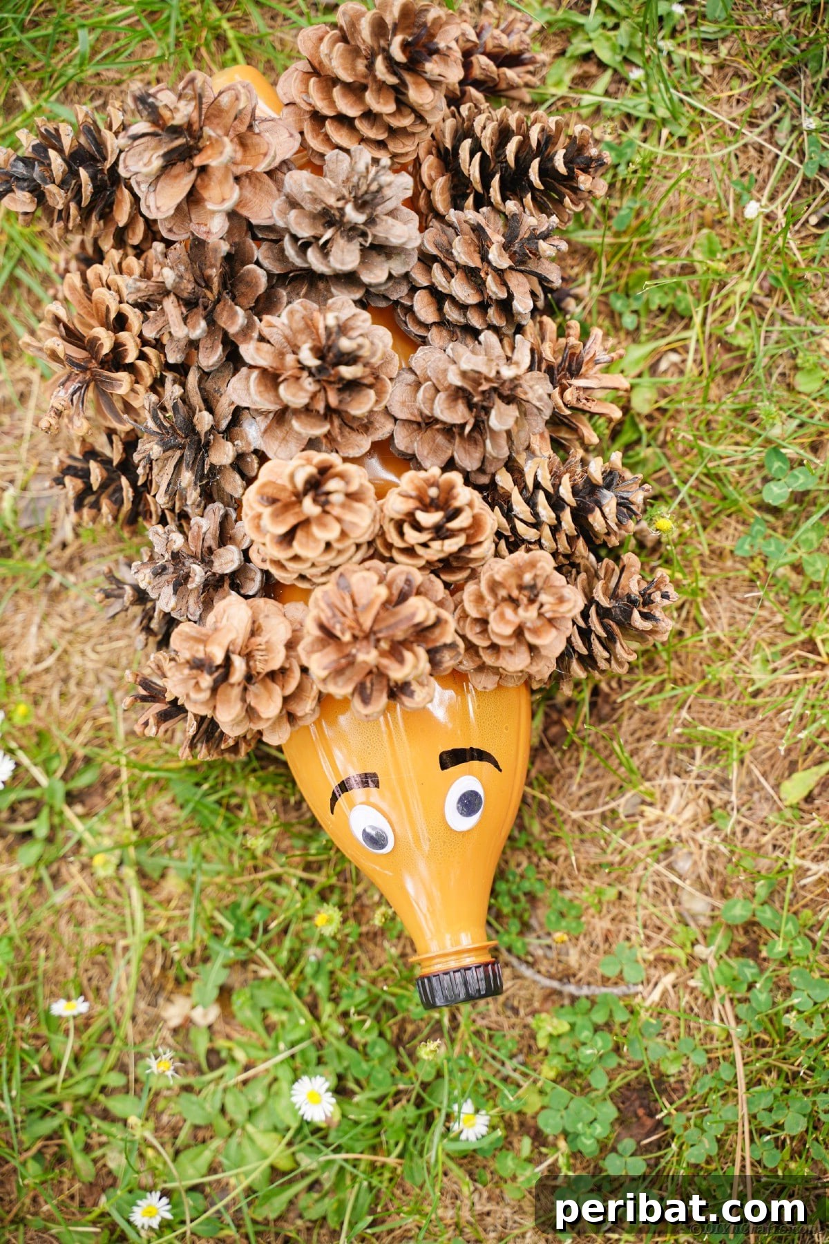 Charming Upcycled Pinecone Hedgehog Art 15 Finished pinecone hedgehog decoration on green grass, ready for fall display