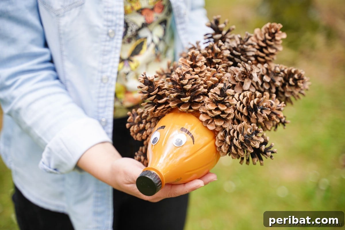 Charming Upcycled Pinecone Hedgehog Art 6 Woman holding a charming pinecone hedgehog, displaying the completed fall craft