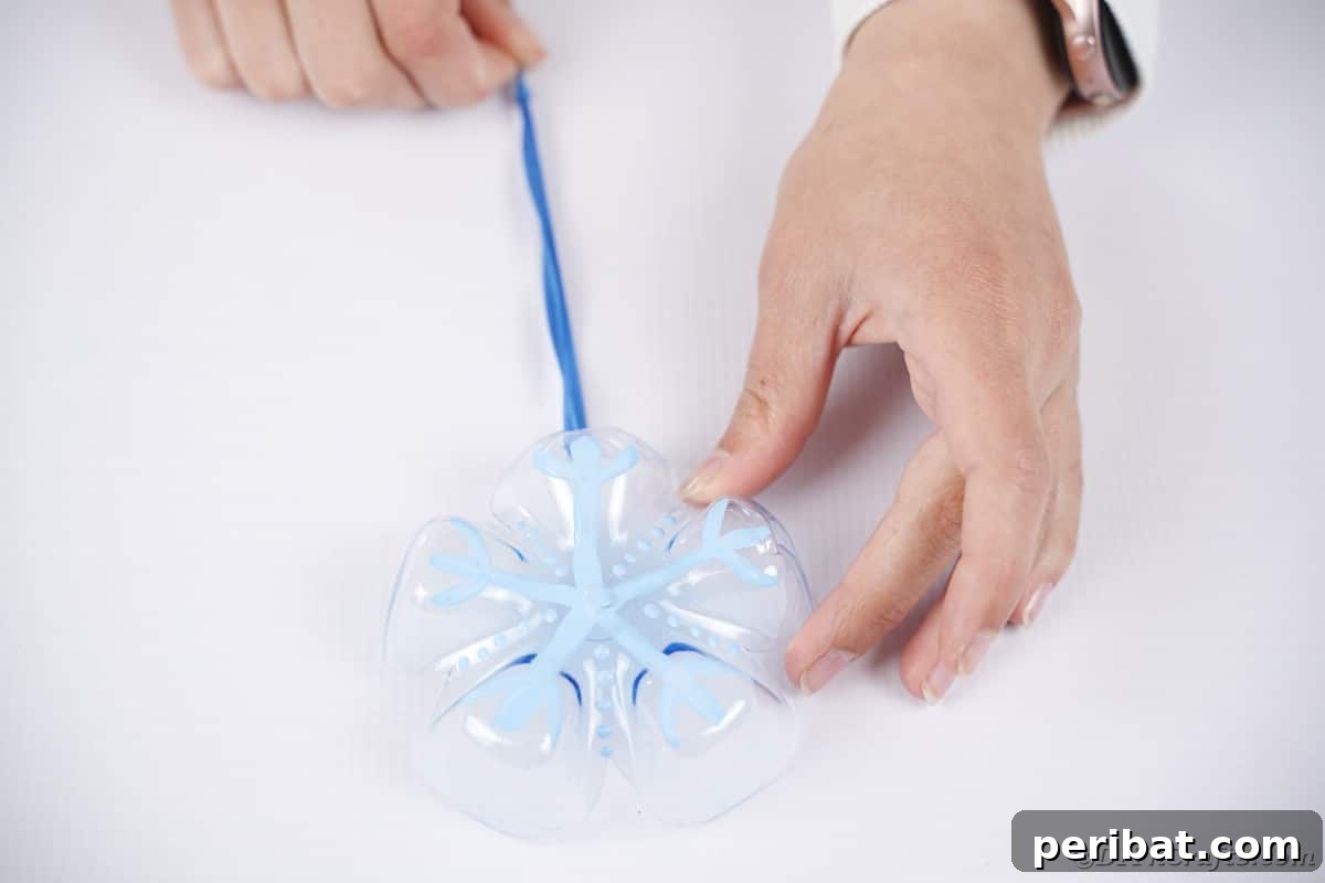 Bottle to Bauble: Stunning Upcycled Snowflakes 15 Ornament on white surface