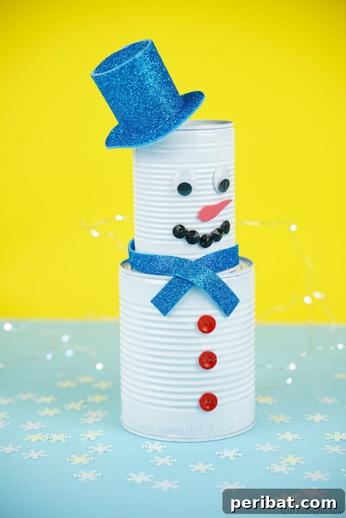 DIY Painted Tin Can Snowman Video Tutorial 29 A tin can snowman with a unique design, set against a bright yellow background, showcasing creative variations.
