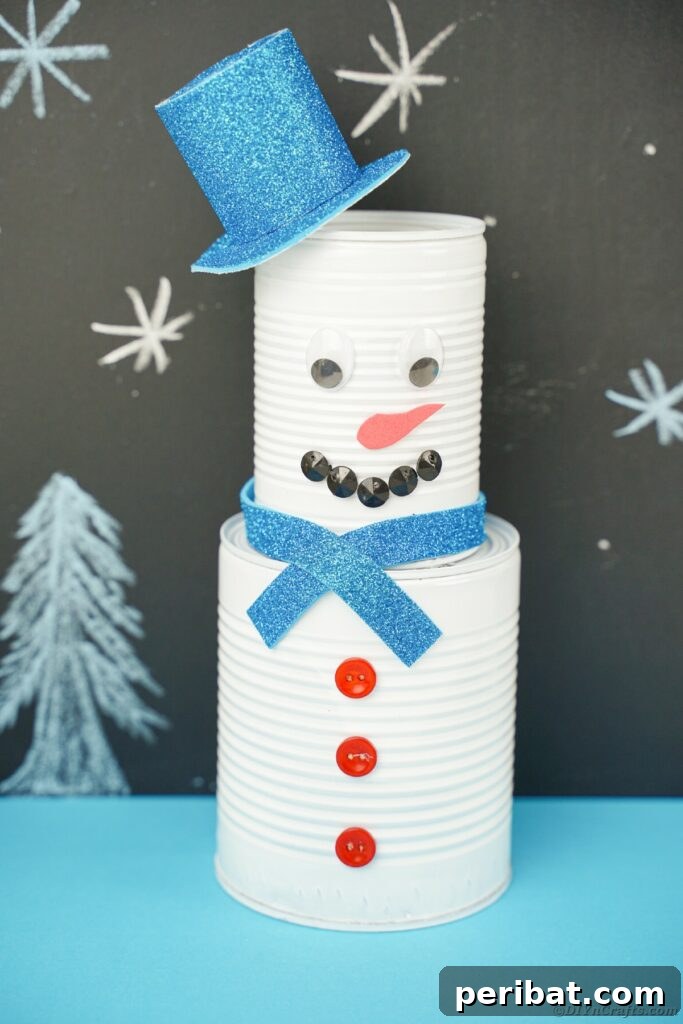 DIY Painted Tin Can Snowman Video Tutorial 30 A beautifully crafted tin can snowman positioned next to a chalkboard, emphasizing its unique handcrafted details and aesthetic appeal.