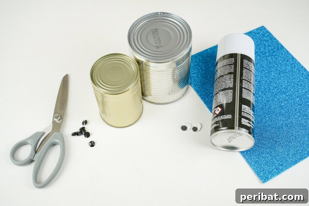 DIY Painted Tin Can Snowman Video Tutorial 7 Various craft supplies laid out, including tin cans, paints, and decorative items, ready to be assembled into a snowman.