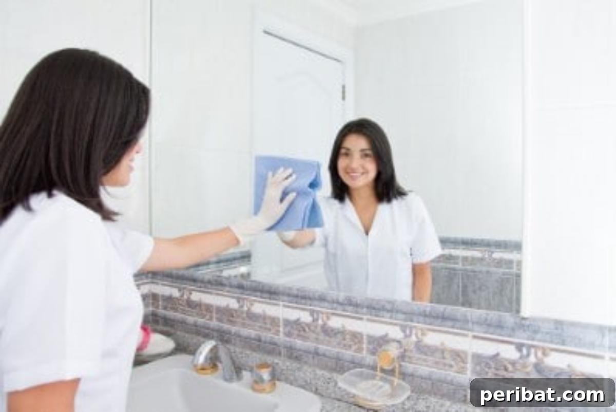 51 Genius Hydrogen Peroxide Hacks 28 A woman is cleaning mirrors