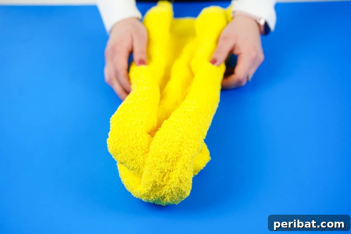 Towel Origami: Animal Edition 11 Folding a yellow towel to create the teddy bear's body