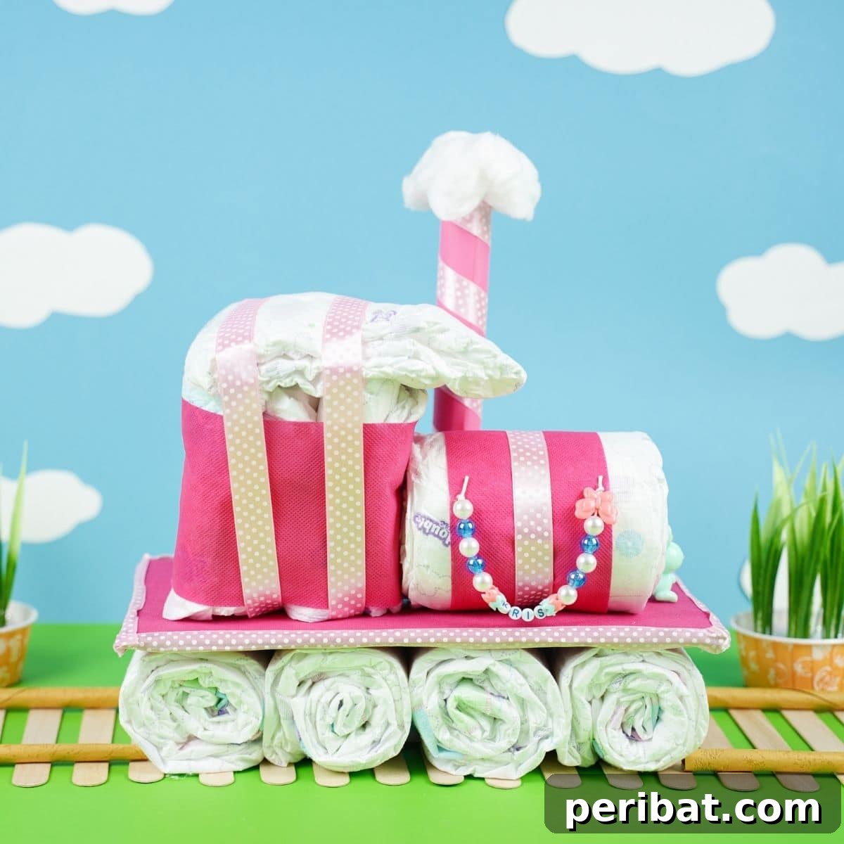 Create a Charming Diaper Train for Baby Shower Joy 2 Adorable diaper cake train displayed on a blue background with whimsical cloud cutouts, perfect for a baby shower centerpiece.