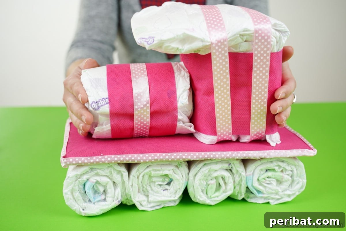 Create a Charming Diaper Train for Baby Shower Joy 21 The top sections of the diaper train being assembled on the cardboard base, bringing the train structure to completion.