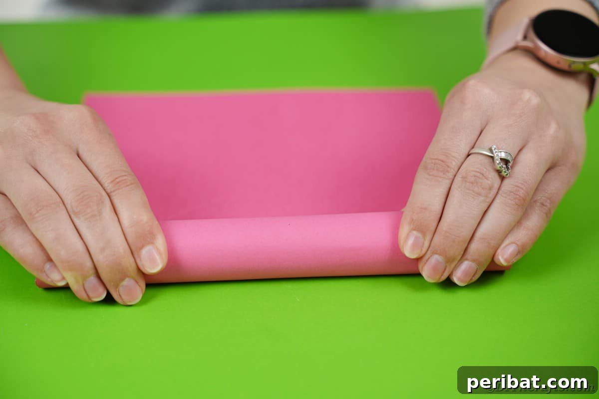 Create a Charming Diaper Train for Baby Shower Joy 22 A cardboard tube being wrapped with tissue paper, transforming it into the smokestack for the diaper cake train.