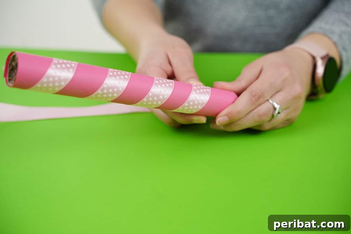Create a Charming Diaper Train for Baby Shower Joy 23 Ribbon being spiraled around a tissue-paper-wrapped cardboard tube, adding a decorative touch to the smokestack.