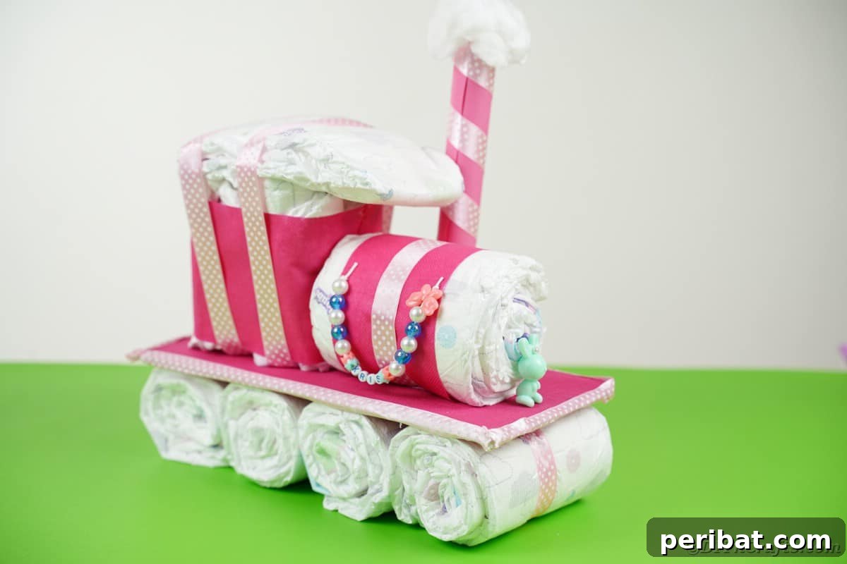 Create a Charming Diaper Train for Baby Shower Joy 27 A completed diaper cake train displayed on a vibrant green table, surrounded by a festive atmosphere.