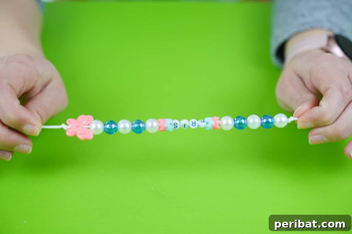 Create a Charming Diaper Train for Baby Shower Joy 8 A length of colorful beads strung on an elastic, ready to be attached as a decorative element to the diaper cake train.