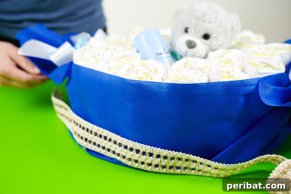 Attaching burlap lace around the bottom edge of the candy diaper cake, adding a rustic and refined trim.
