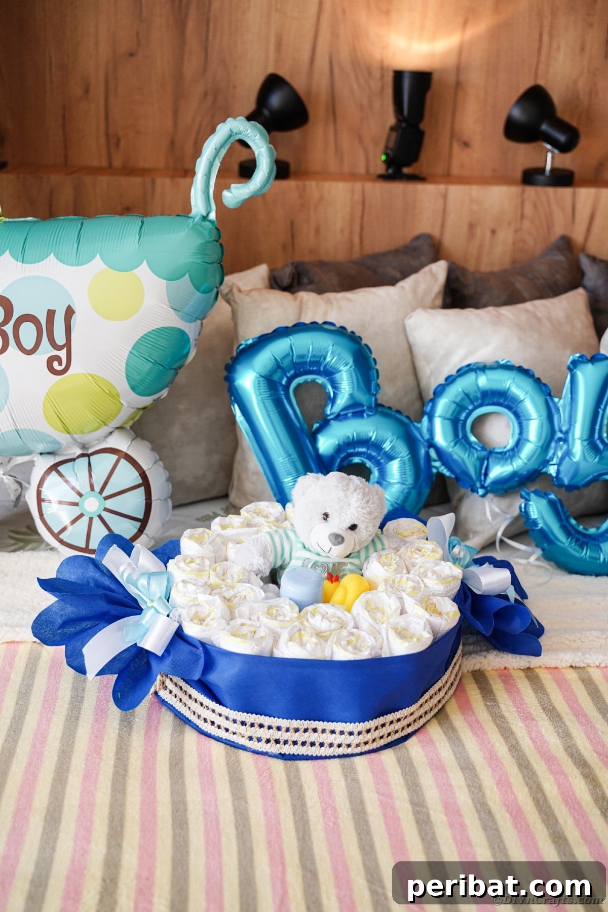 A beautifully completed candy wrapper diaper cake resting on a cozy bed, adorned with ribbons and ready to be gifted.