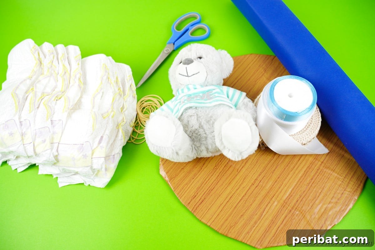 An organized collection of supplies laid out for creating a diaper cake, including diapers, ribbons, and a teddy bear.