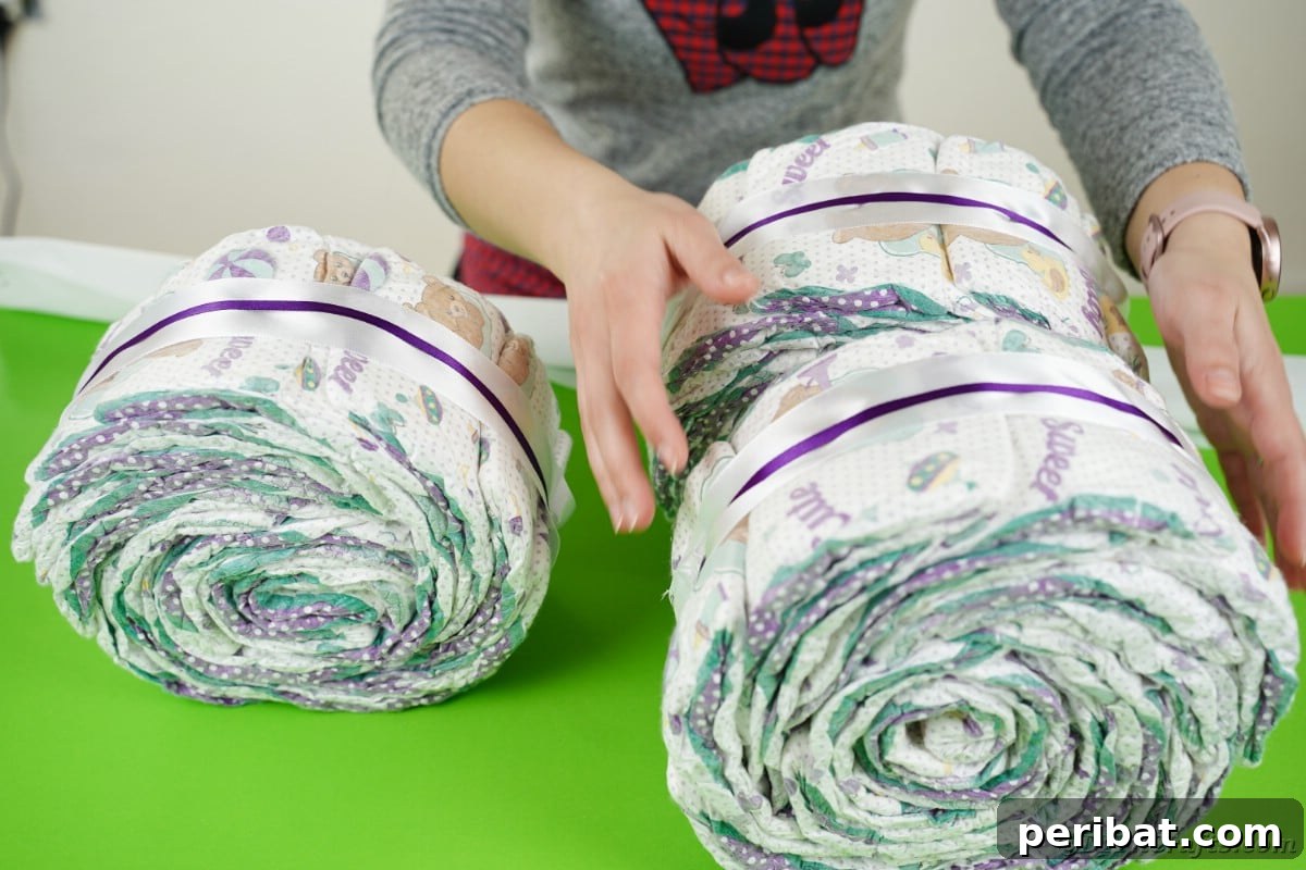 Stacking diaper rolls to form the tricycle shape